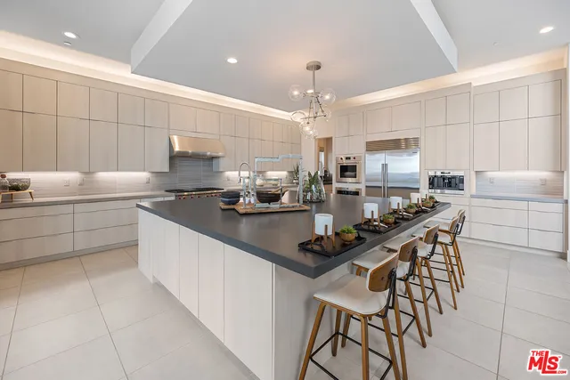 a kitchen with stainless steel appliances kitchen island granite countertop a sink and cabinets