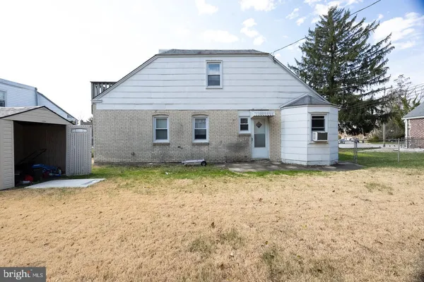 a view of a house with a yard covered in snow