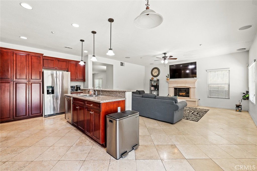 4816 Gregory Road Riverside, CA 92501 - Photo 13 of 55 a large kitchen with stainless steel appliances granite countertop a stove and a refrigerator