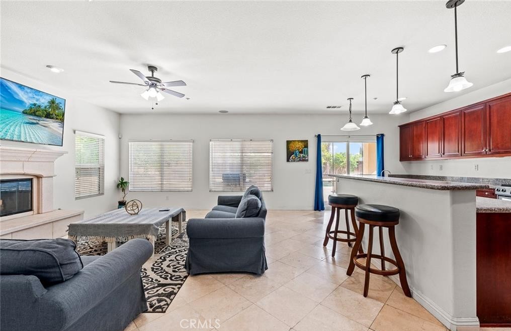 4816 Gregory Road Riverside, CA 92501 - Photo 15 of 55 a living room with furniture a fireplace and a flat screen tv