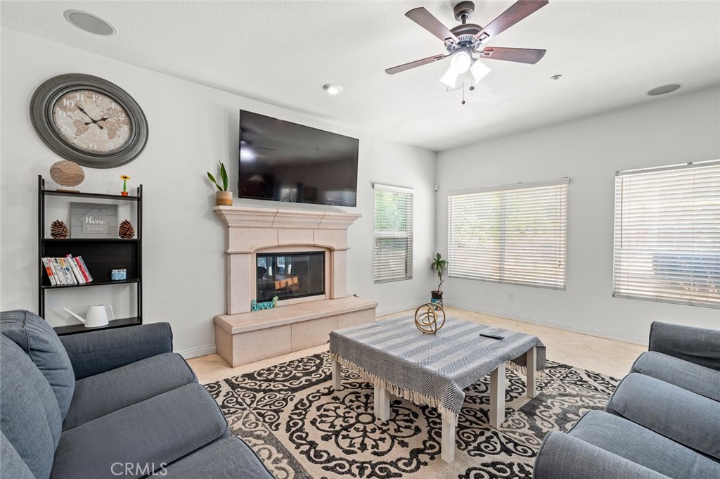 4816 Gregory Road Riverside, CA 92501 - Photo 19 of 55 a living room with furniture a flat screen tv and a fireplace