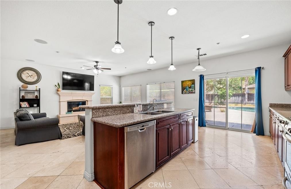 4816 Gregory Road Riverside, CA 92501 - Photo 20 of 55 a large kitchen with stainless steel appliances granite countertop a stove and a view of living room