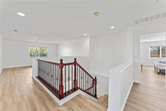 a view of kitchen with kitchen island sink and wooden floor