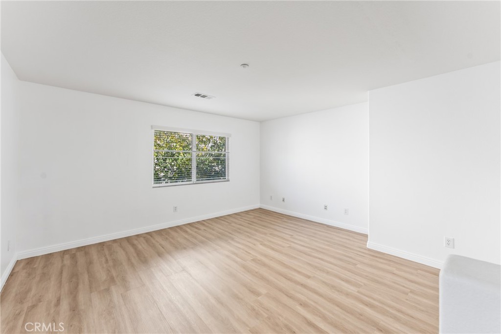 4816 Gregory Road Riverside, CA 92501 - Photo 24 of 55 an empty room with wooden floor and window
