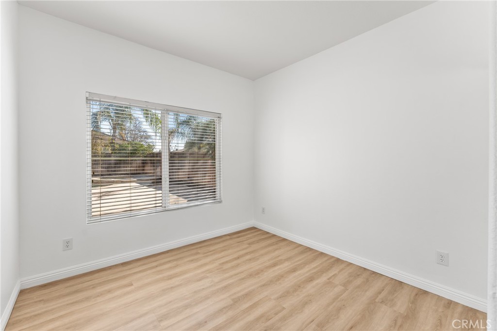 4816 Gregory Road Riverside, CA 92501 - Photo 25 of 55 a view of an empty room with wooden floor and a window