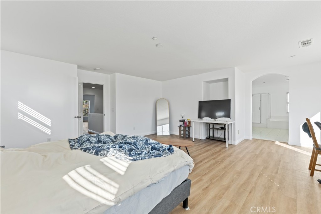 4816 Gregory Road Riverside, CA 92501 - Photo 35 of 55 a living room with furniture a flat screen tv and a refrigerator