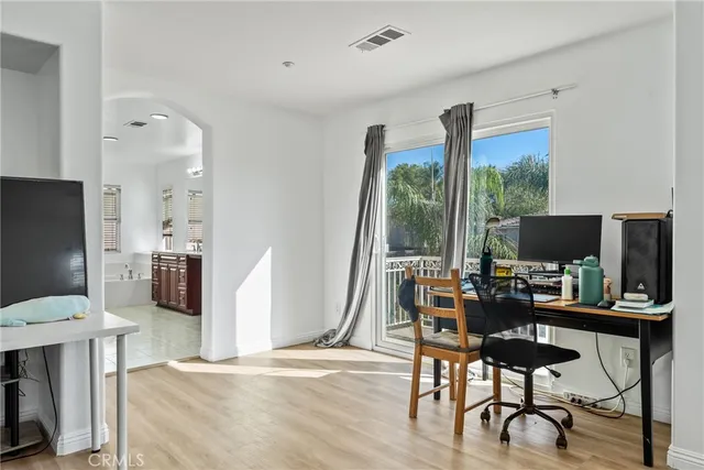 a large bathroom with a granite countertop double vanity sink a mirror and a bathtub