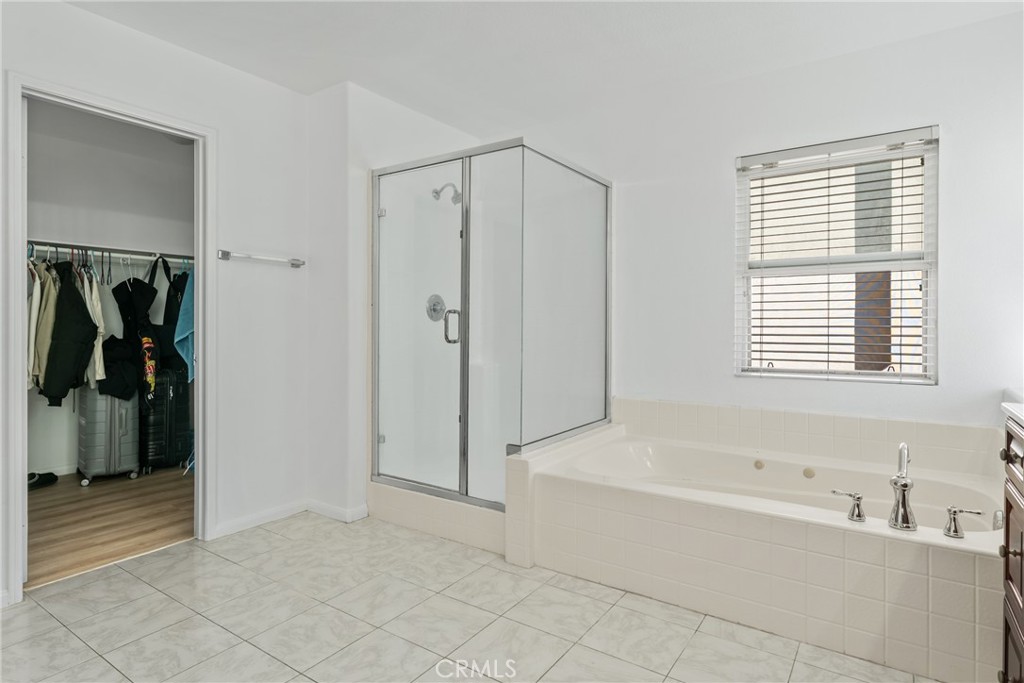 4816 Gregory Road Riverside, CA 92501 - Photo 39 of 55 a bathroom with a bathtub and a shower