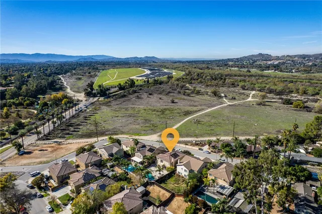 an aerial view of a house with a swimming pool
