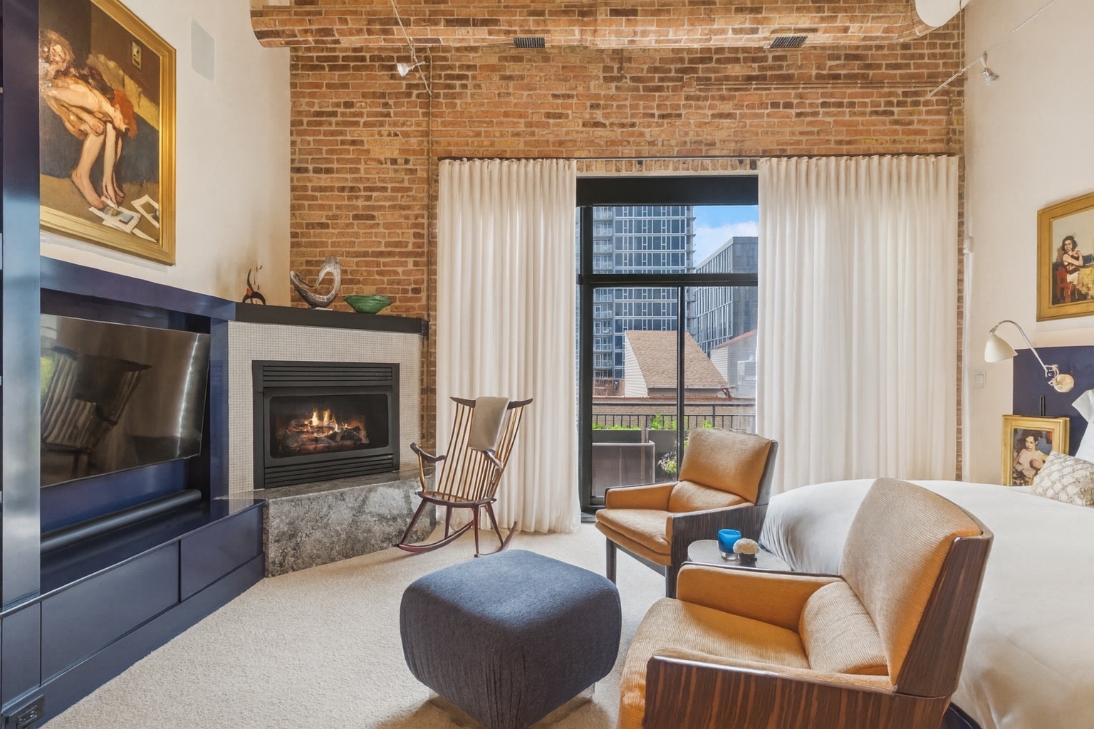 23 North Green Street, Unit 504 Chicago, IL 60607 - Photo 16 of 30 a living room with furniture a fireplace and a floor to ceiling window