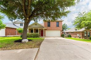 View of front of house with a porch, concrete driveway, a garage, and a front lawn