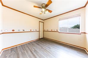 805 Chiselpoint Cove Round Rock, TX 78681 - Photo 12 of 38 Empty room featuring crown molding, light wood-style flooring, and ceiling fan