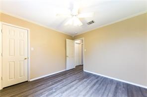 805 Chiselpoint Cove Round Rock, TX 78681 - Photo 19 of 38 Unfurnished bedroom featuring dark wood-style floors, a ceiling fan, and ornamental molding