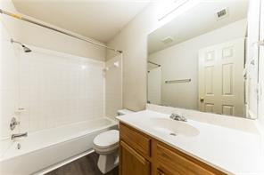 805 Chiselpoint Cove Round Rock, TX 78681 - Photo 20 of 38 Full bath featuring vanity, shower / bathtub combination, and dark wood-style floors