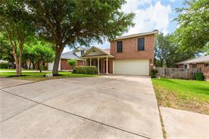 805 Chiselpoint Cove Round Rock, TX 78681 - Photo 2 of 38 Traditional-style home with a front yard, a garage, and driveway