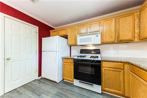 805 Chiselpoint Cove Round Rock, TX 78681 - Photo 28 of 38 Kitchen featuring white appliances, dark wood-style floors, and light countertops