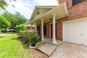 805 Chiselpoint Cove Round Rock, TX 78681 - Photo 4 of 38 View of exterior entry featuring a porch, brick siding, a yard, and a garage