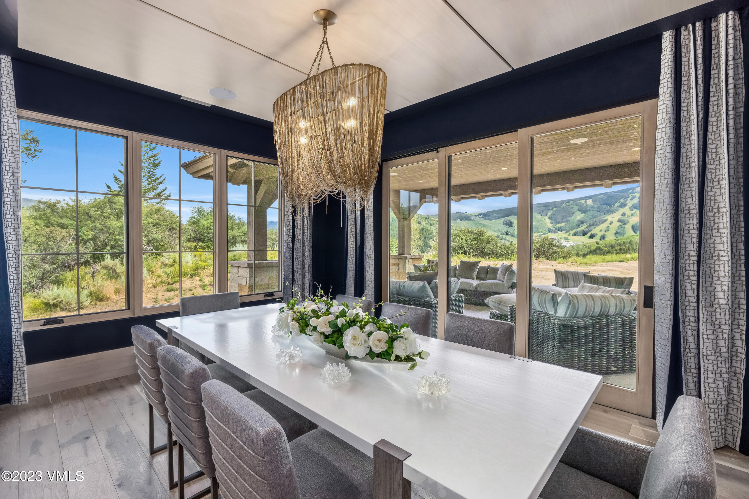335 Elkhorn Avon, CO 81620 - Photo 19 of 73 a dining room with furniture a chandelier and wooden floor