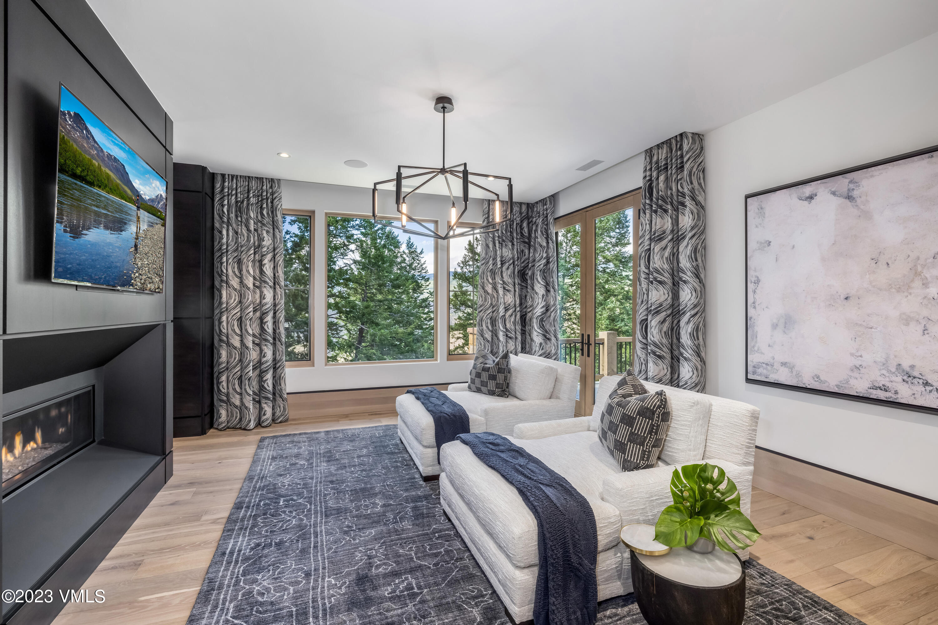 335 Elkhorn Avon, CO 81620 - Photo 26 of 73 a living room with furniture a flat screen tv and a floor to ceiling window