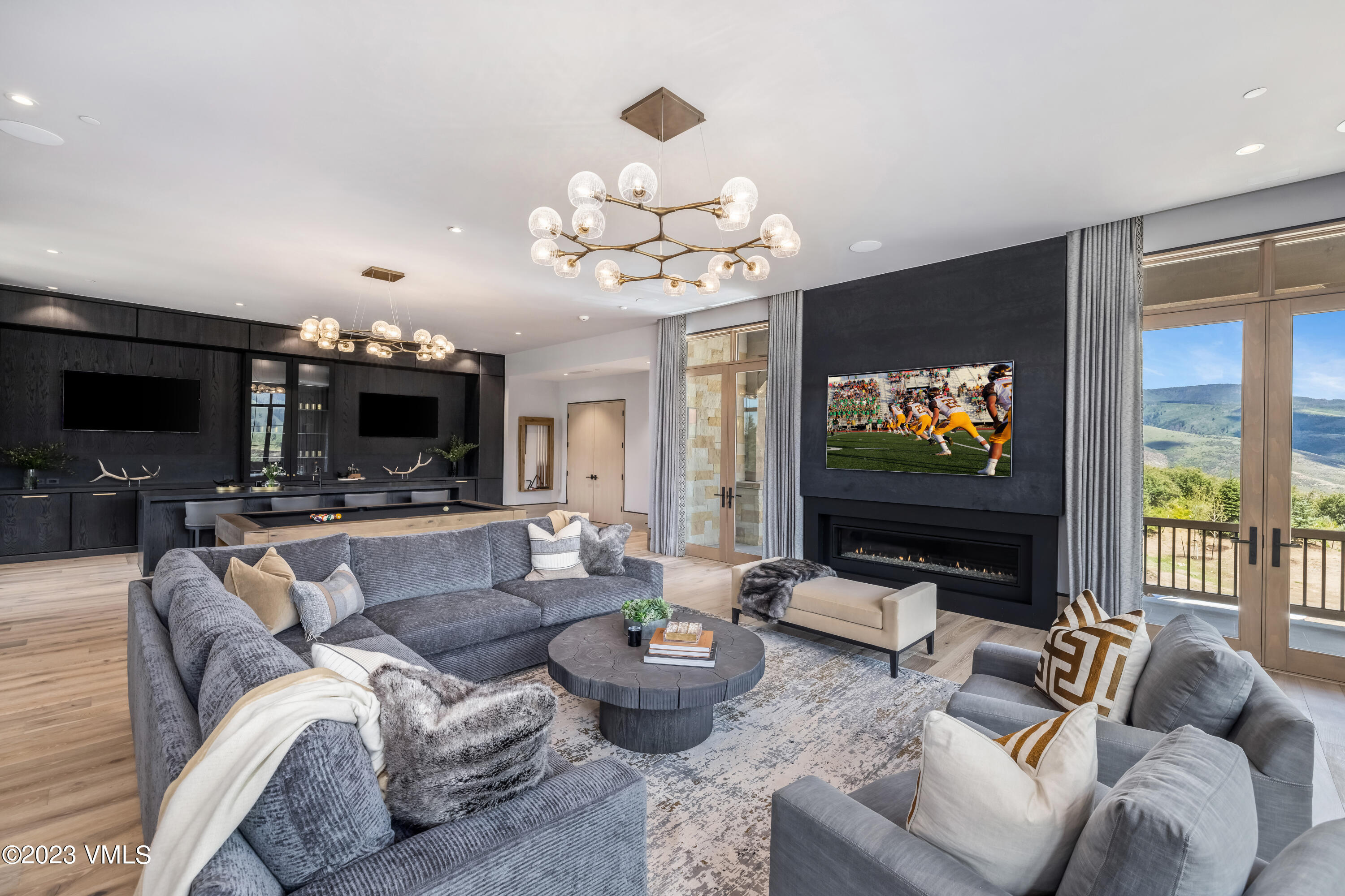 335 Elkhorn Avon, CO 81620 - Photo 35 of 73 a living room with furniture a flat screen tv and a large window