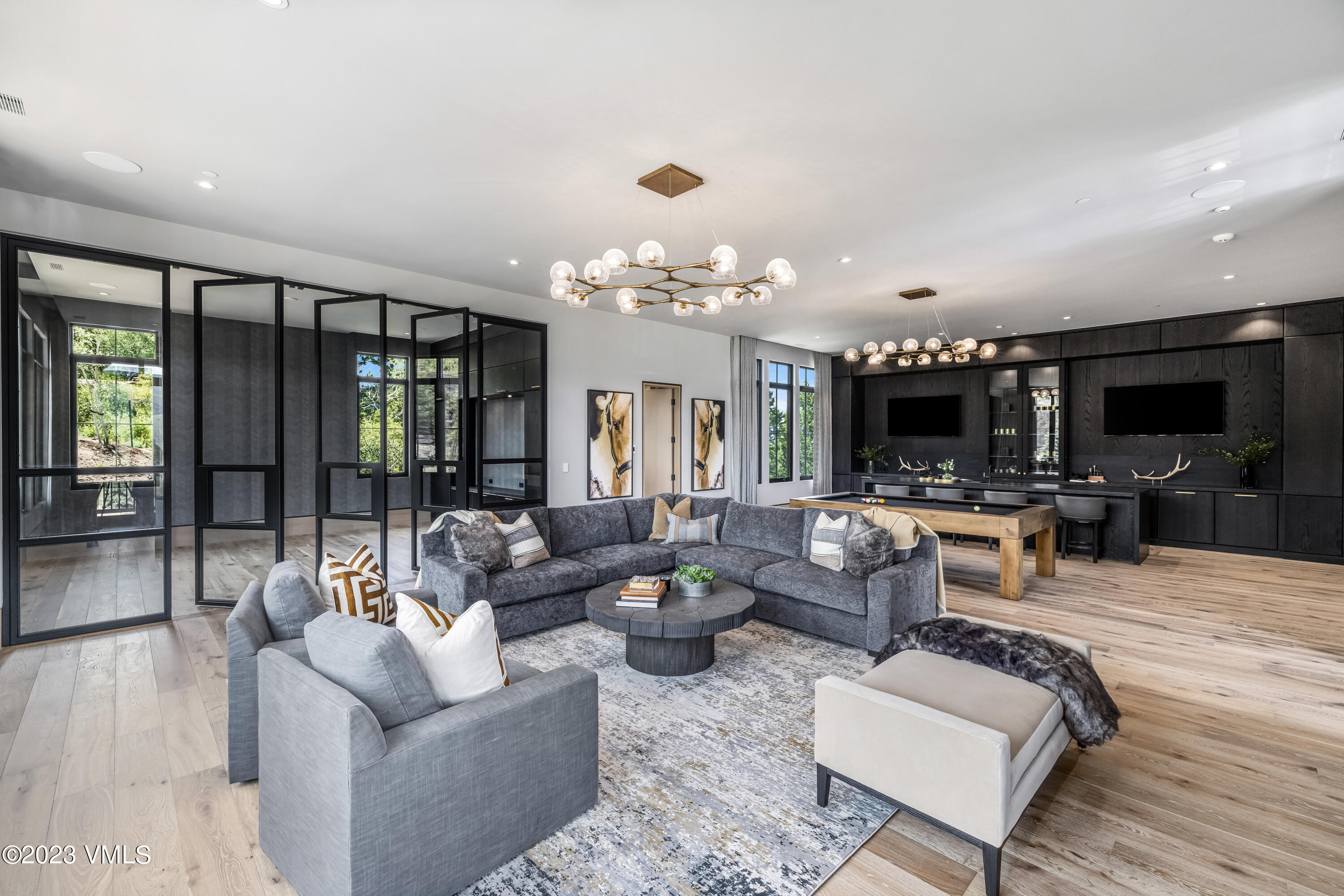 335 Elkhorn Avon, CO 81620 - Photo 37 of 73 a living room with furniture and a chandelier