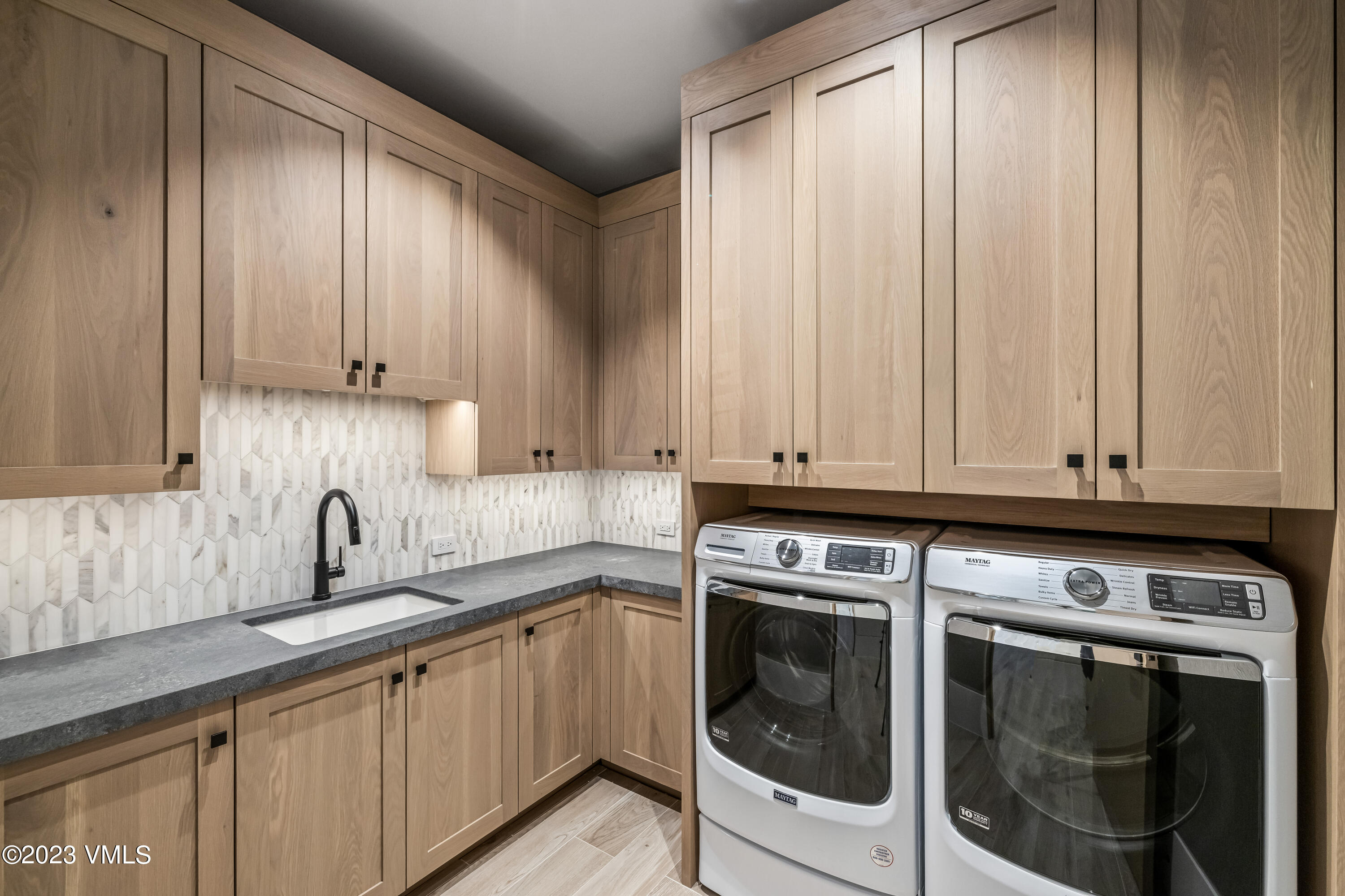 335 Elkhorn Avon, CO 81620 - Photo 44 of 73 a kitchen with granite countertop white cabinets and stainless steel appliances