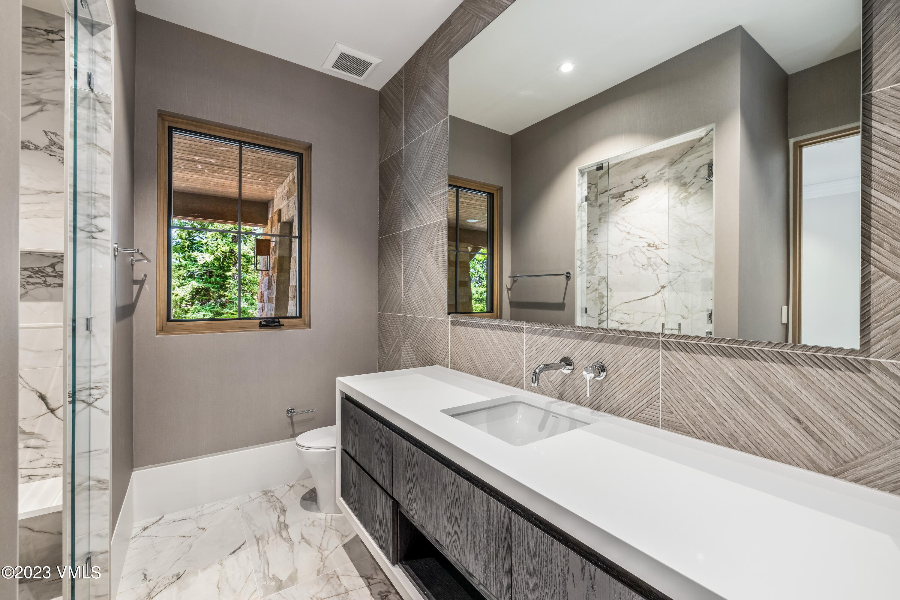 335 Elkhorn Avon, CO 81620 - Photo 57 of 73 a bathroom with a granite countertop sink a large mirror and a window