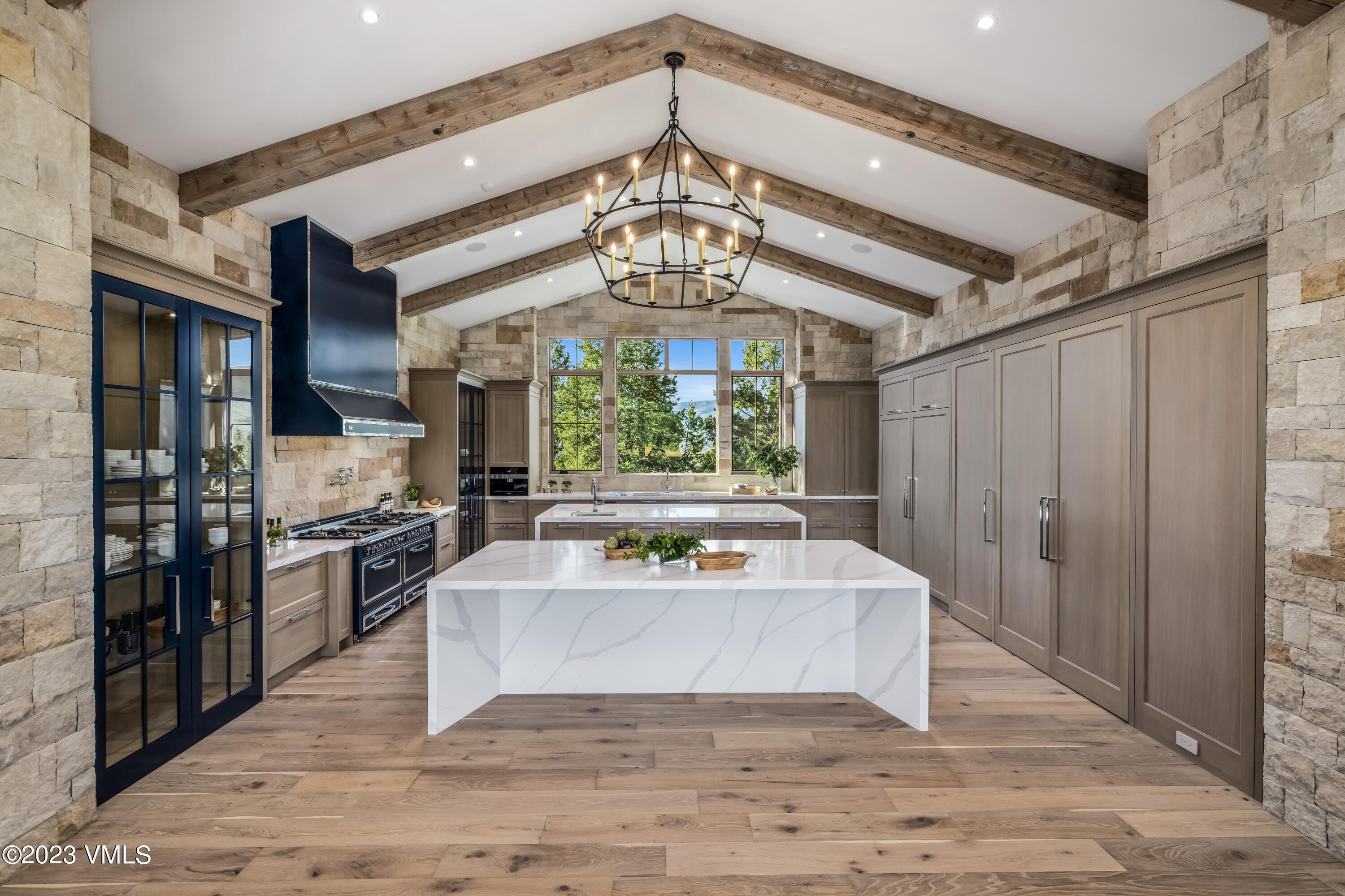 335 Elkhorn Avon, CO 81620 - Photo 9 of 73 a living room with stainless steel appliances kitchen island granite countertop furniture and a chandelier