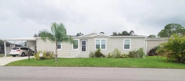 a view of a house with a yard and a street