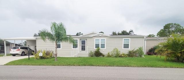 a view of a house with a yard and a street