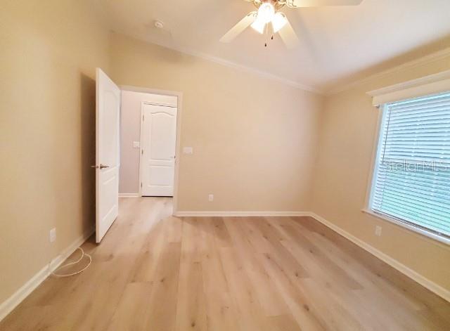 12116 Southwest County 769 Rd Lake, Unit 121 Lake Suzy, FL 34269 - Photo 13 of 45 wooden floor in an empty room with a window