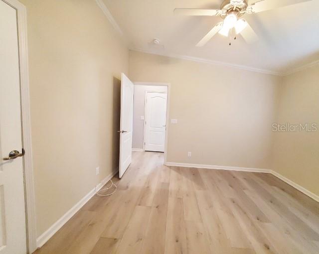 12116 Southwest County 769 Rd Lake, Unit 121 Lake Suzy, FL 34269 - Photo 15 of 45 an empty room with wooden floor and fan