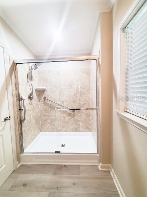 12116 Southwest County 769 Rd Lake, Unit 121 Lake Suzy, FL 34269 - Photo 18 of 45 a bathroom with a glass shower door and mirror
