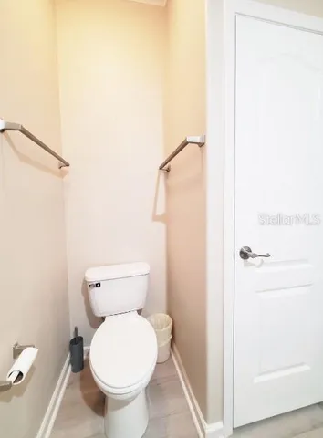 a white toilet sitting next to a window