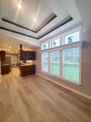 a view of kitchen with furniture and wooden floor