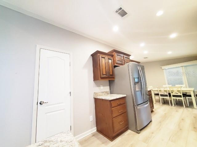 12116 Southwest County 769 Rd Lake, Unit 121 Lake Suzy, FL 34269 - Photo 29 of 45 a view of kitchen with furniture and wooden floor