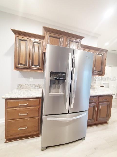 12116 Southwest County 769 Rd Lake, Unit 121 Lake Suzy, FL 34269 - Photo 32 of 45 a refrigerator freezer sitting in a kitchen