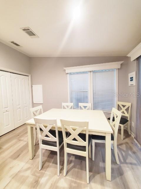 12116 Southwest County 769 Rd Lake, Unit 121 Lake Suzy, FL 34269 - Photo 34 of 45 a view of a dining room with furniture and wooden floor