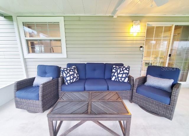 12116 Southwest County 769 Rd Lake, Unit 121 Lake Suzy, FL 34269 - Photo 36 of 45 a living room with furniture and a large window