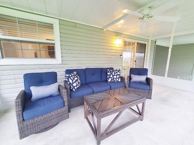 12116 Southwest County 769 Rd Lake, Unit 121 Lake Suzy, FL 34269 - Photo 37 of 45 a living room with furniture and a large window