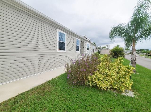 12116 Southwest County 769 Rd Lake, Unit 121 Lake Suzy, FL 34269 - Photo 40 of 45 a front view of a house with garden
