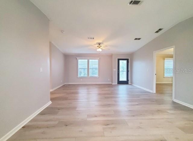 12116 Southwest County 769 Rd Lake, Unit 121 Lake Suzy, FL 34269 - Photo 4 of 45 a view of an empty room with window and wooden floor