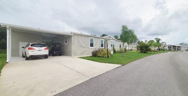 12116 Southwest County 769 Rd Lake, Unit 121 Lake Suzy, FL 34269 - Photo 44 of 45 a car parked in front of white house