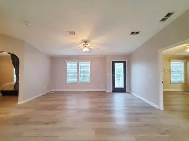 a bedroom with a bed and a flat tv screen on dresser
