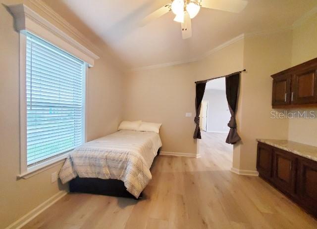 12116 Southwest County 769 Rd Lake, Unit 121 Lake Suzy, FL 34269 - Photo 7 of 45 a bedroom with a bed and a flat tv screen on dresser