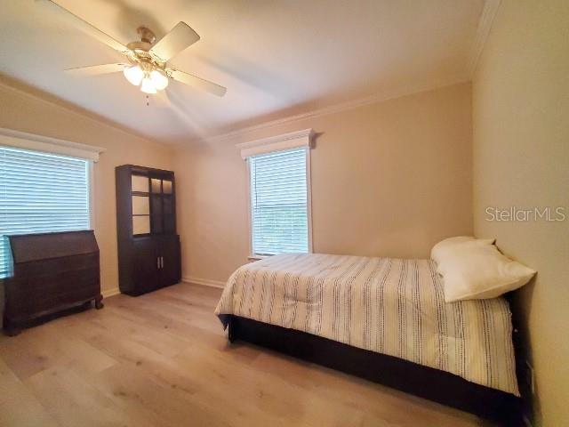 12116 Southwest County 769 Rd Lake, Unit 121 Lake Suzy, FL 34269 - Photo 9 of 45 a bedroom with a bed and a chandelier