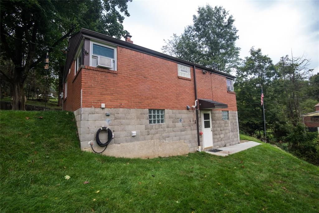 2919 Laketon Road Pittsburgh, PA 15235 - Photo 17 of 19 View of rear of home with concrete patio directly off of the walkout basement.