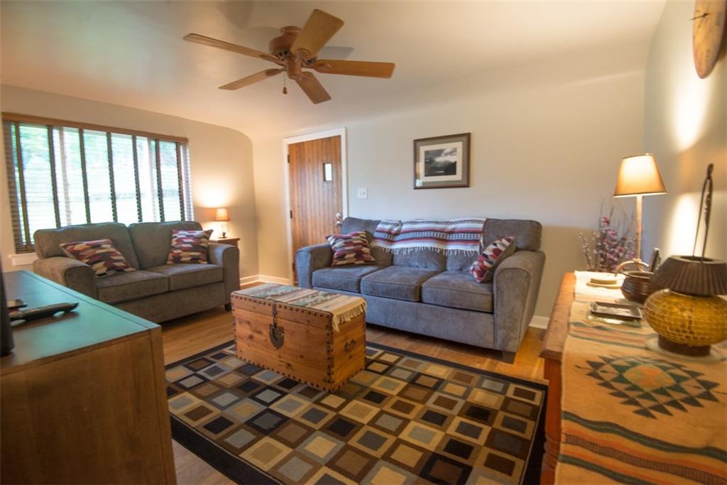 Additional view of living room with large picture window allowing a lot of natural light to come in.  
