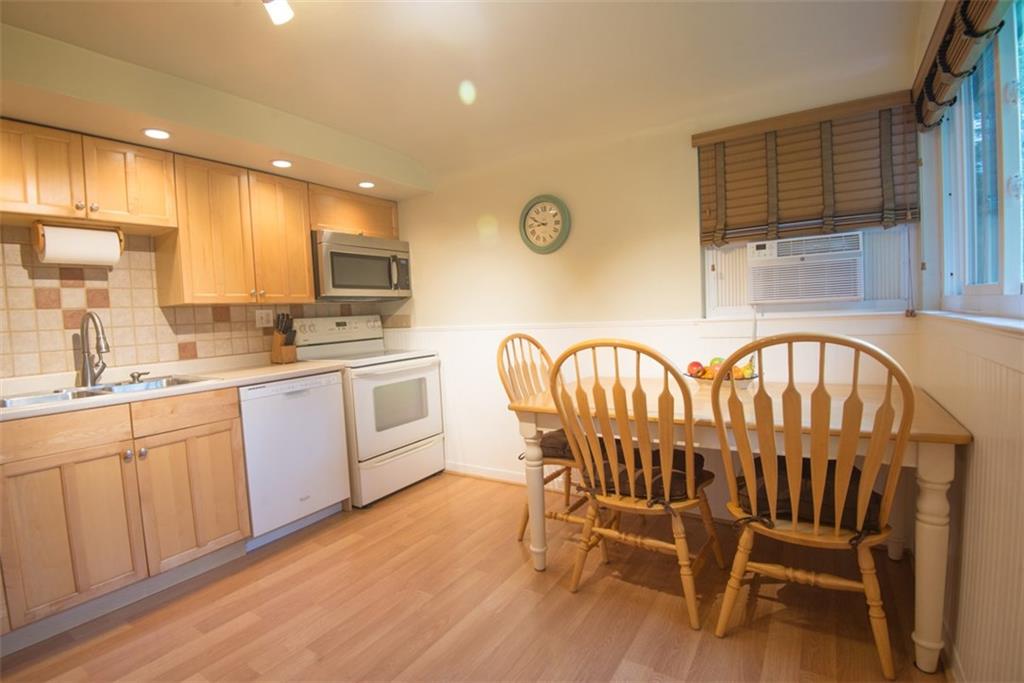 Additional view of kitchen with ceramic backsplash, recessed lighting, and two windows making this very bright.  Please note table can be pulled away from wall to allow for additional seating.  