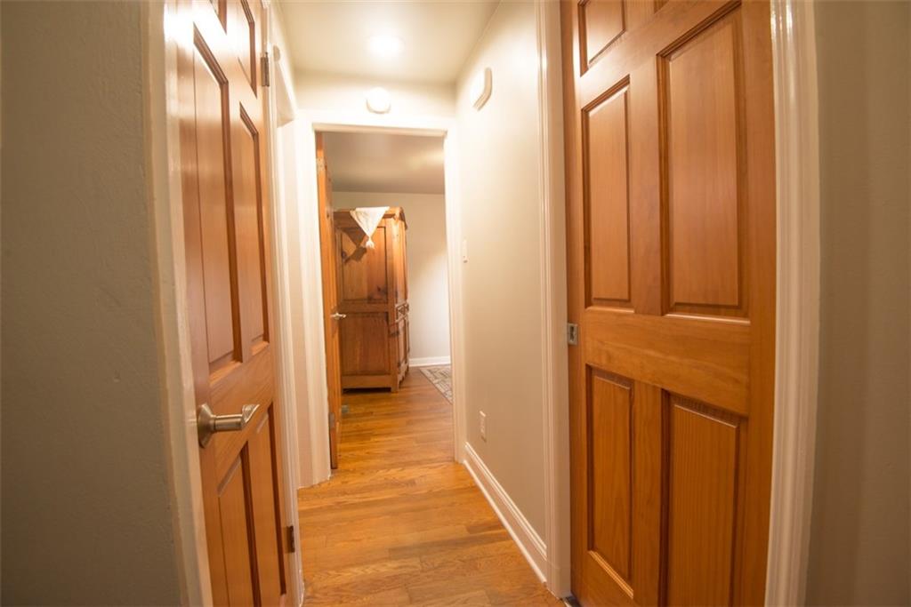 Hallway to both bedrooms and bath.  All the interior doors have been replaced with solid wood six panel doors.  